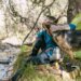 Portable camping water filter straw resting beside a stream for outdoor backpacking and camping trips