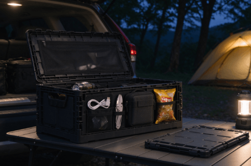 Collapsible camping storage organizer on wooden campsite table, organized camping gear inside, tent background