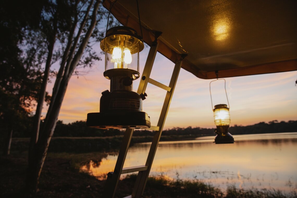 Multi-purpose aluminum camping lantern hook hanging an LED lantern inside tent at campsite